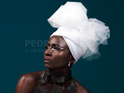 Buy stock photo Beauty, fashion and serious black woman in turban and makeup in studio isolated on a blue background. African model, cosmetics and head scarf with face for traditional style, elegance and thinking