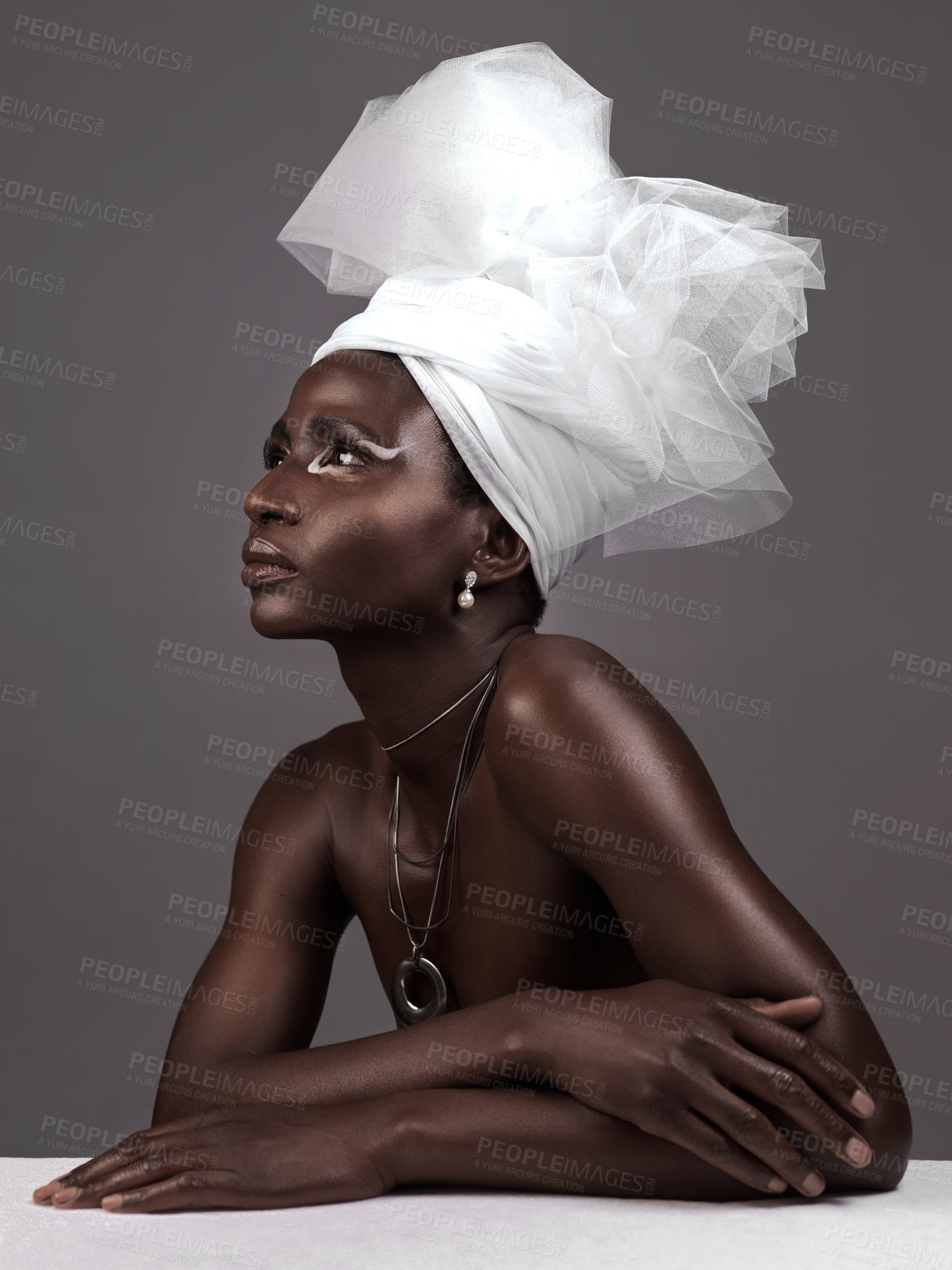 Buy stock photo Studio shot of an attractive young woman posing in traditional African attire against a grey background