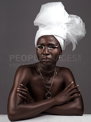 Buy stock photo Studio portrait of an attractive young woman posing in traditional African attire against a grey background