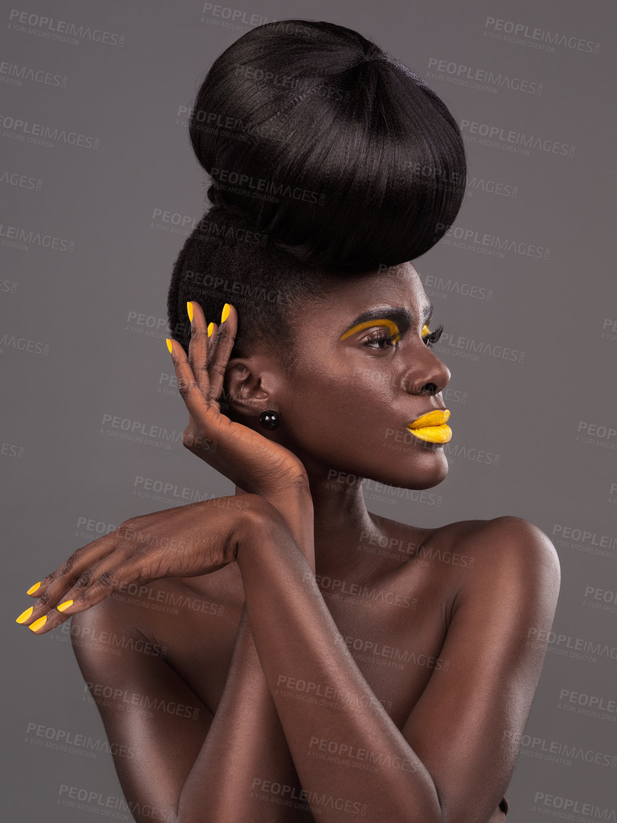Buy stock photo African, model and studio face with creative, beauty and cosmetic yellow lipstick. Bold, woman and skin with confidence, dramatic hair and bun for glamour or trendy makeup isolated on grey background