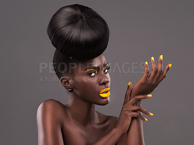 Buy stock photo African, model and style portrait for makeup, beauty and creative yellow lipstick. Bold, woman or skin with confidence, dramatic hair and bun for glamour or trendy cosmetics on grey studio background