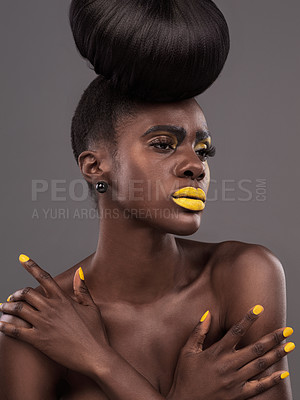 Buy stock photo African, model and studio color with makeup, beauty and creative yellow lipstick. Bold, woman and skin with confidence, dramatic hair and bun for glamour and trendy cosmetics on grey background