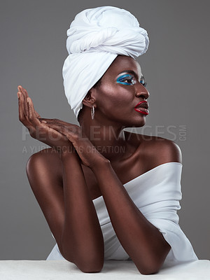 Buy stock photo Studio shot of an attractive young woman posing in traditional African attire against a grey background