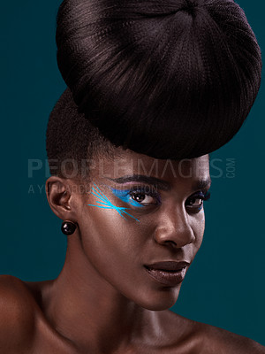 Buy stock photo Portrait, hair and cosmetics with a model black woman in studio on a blue background for beauty. Face, haircare and makeup with an attractive young female person at the salon for fashion or styling