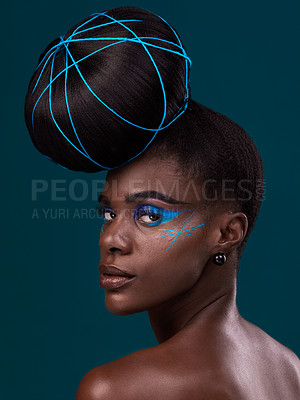 Buy stock photo Portrait, hair and back with a model black woman in studio on a blue background for beauty. Face, haircare and makeup with an attractive young female person looking over her shoulder at the salon