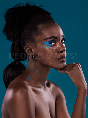 Buy stock photo Portrait, natural hair and cosmetics with a black woman in studio on a blue background for beauty. Face, haircare and makeup with an attractive young female model at the salon for fashion or styling