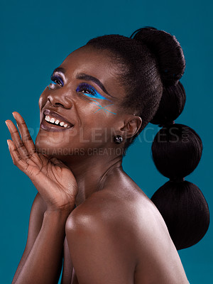 Buy stock photo Thinking, happy and makeup with a model black woman in studio on a blue background for hair or cosmetics. Face, idea and fashion with an attractive young female person posing for cosmetic beauty