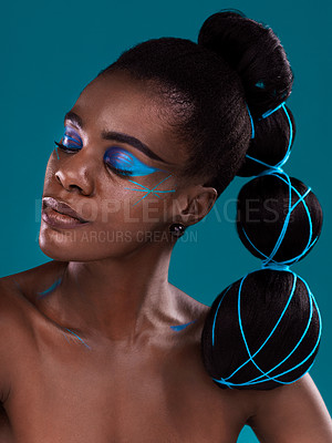 Buy stock photo Face, beauty and makeup with an african woman in studio on a blue background for hair or cosmetics. Eye shadow, haircare and fashion with an attractive young female model at the salon for style