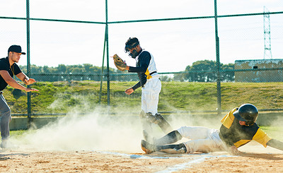 Buy stock photo Full length shot of a young baseball player reaching base during a game on the field