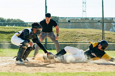 Buy stock photo Cropped shot of a young baseball player reaching base during a match on the field