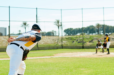 Buy stock photo Cropped shot of a handsome young baseball player preparing to pitch a ball during a match on the field
