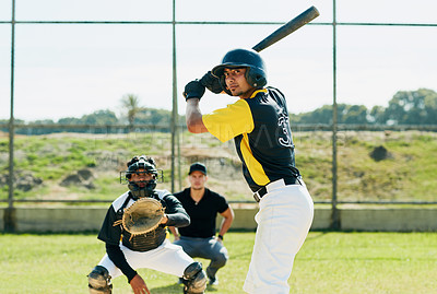 Buy stock photo Cropped shot of a handsome young baseball player preparing to bat a ball during match on the field