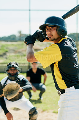 Buy stock photo Cropped shot of a handsome young baseball player preparing to bat a ball during  a game on the field