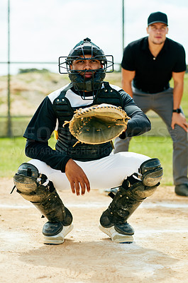 Buy stock photo Cropped shot of a handsome young baseball player preparing to catch a ball during  a game on the field
