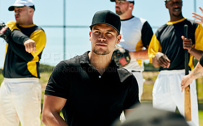 Buy stock photo Cropped shot of a handsome young baseball coach looking thoughtful while standing on the field during the day