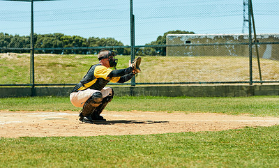 Buy stock photo Full length shot of a young baseball player preparing to catch a ball during a match on the field