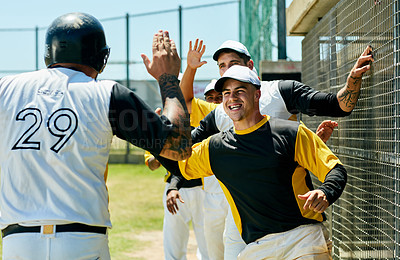 Buy stock photo Cropped shot of a group of young baseball players cheering while standing near a baseball field during the day