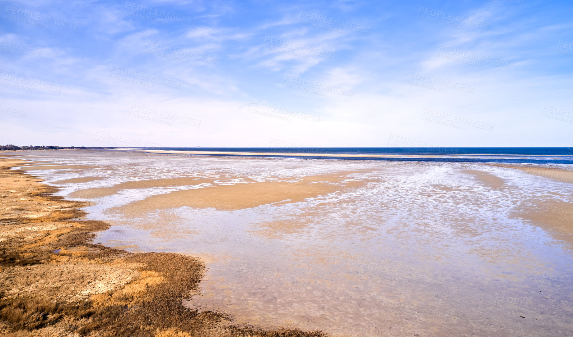 Buy stock photo Landscape of beach sand with ocean and blue cloudy sky background on the Eastcoast shoreline line Kattegat, Jutland, near Mariager fjord, Denmark. Scenic view of sea water on sand during the tide 