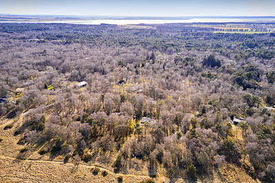 Buy stock photo Rural landscape of farmland in countryside for traveling to private homes in Eastcoast (Kattegat), Jutland, close to Mariager fjord in Denmark. Aerial view of trees and country houses in Spring. 