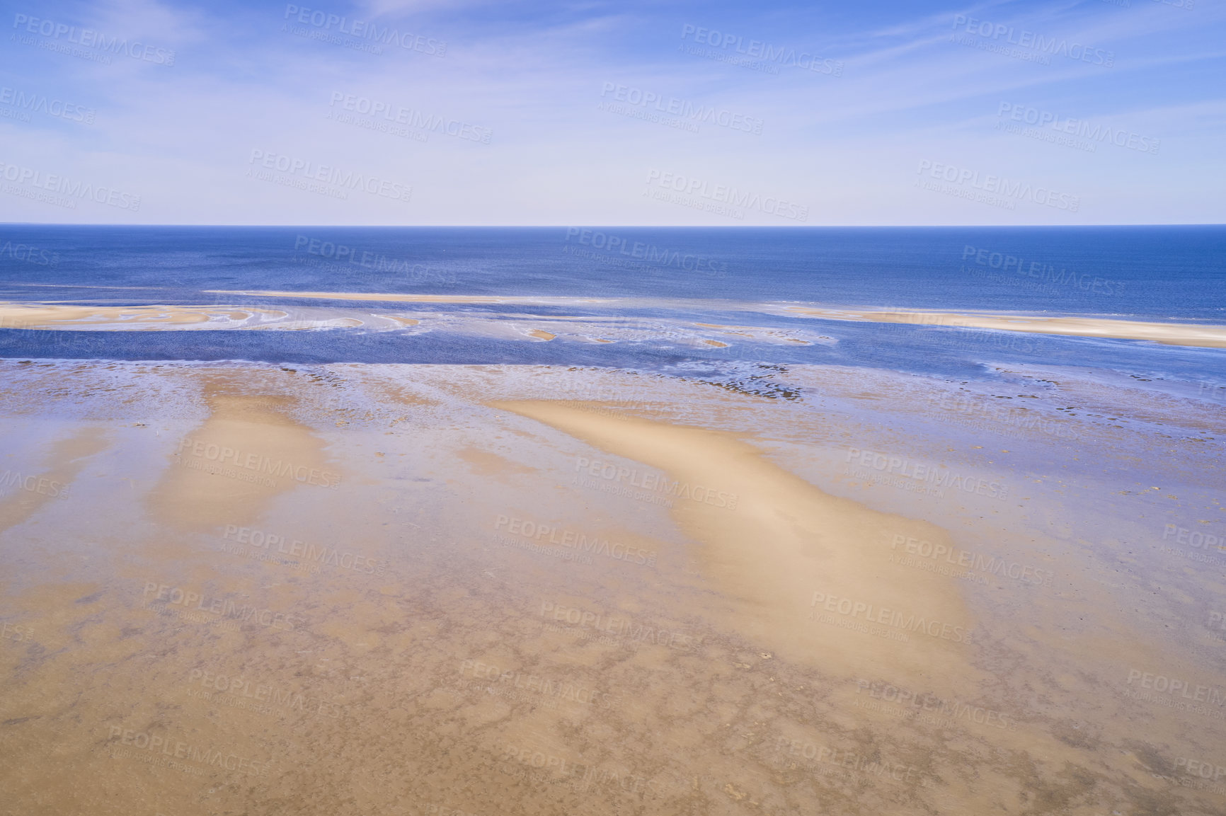 Buy stock photo Landscape of a beach shore and blue sky over the horizon in the background with copy space on a summer day. A peaceful and scenic view of endless sandy water of the sea or ocean during low tide