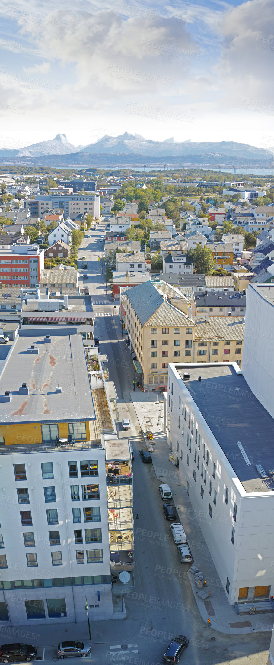 Buy stock photo Above view of urban city streets in popular overseas travel destination in Bodo, Norway. Busy downtown centre and urban infrastructure of building architecture with scenic mountains in the background