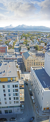 Buy stock photo Above view of urban city streets in popular overseas travel destination in Bodo, Norway. Busy downtown centre and urban infrastructure of building architecture with scenic mountains in the background