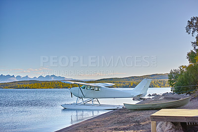 Buy stock photo A seaplane on a lake in summer on standby. Landscape of a small aircraft or floatplane ready for takeoff for a scenic sightseeing travel flight across a beautiful countryside or nature environment