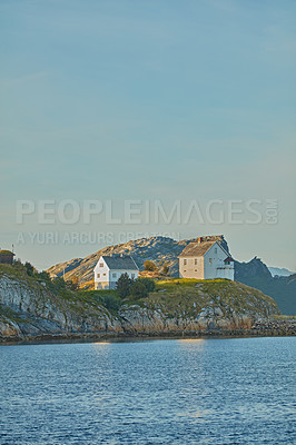 Buy stock photo A lighthouse or holiday home by the lake. An old museum called Nyholmen in Bodo or remote getaway house on a mountain by the river. Landscape of an island with a historic building by the sea and sky