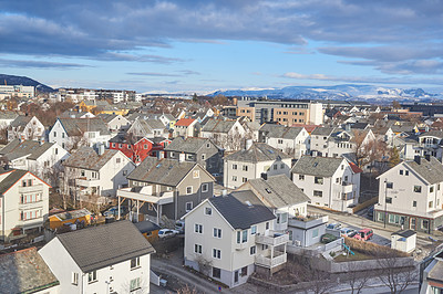 Buy stock photo The small city of Bodo in Norway with a cloudy or overcast blue sky. A beautiful scenic view of urban landscape streets and buildings with copy space. Peaceful rural town from above