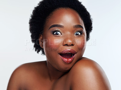 Buy stock photo Studio shot of a beautiful young woman looking shocked against a gray background