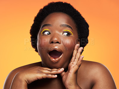 Buy stock photo Studio shot of a beautiful young woman looking shocked against an orange background