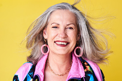 Buy stock photo Portrait of a cheerful and stylish senior woman posing against a yellow background