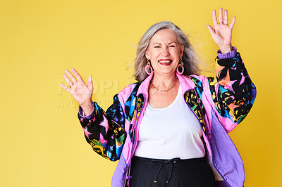 Buy stock photo Portrait of a cheerful and stylish senior woman posing against a yellow background