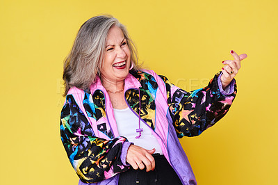 Buy stock photo Cropped shot of a cheerful and stylish senior woman posing against a yellow background