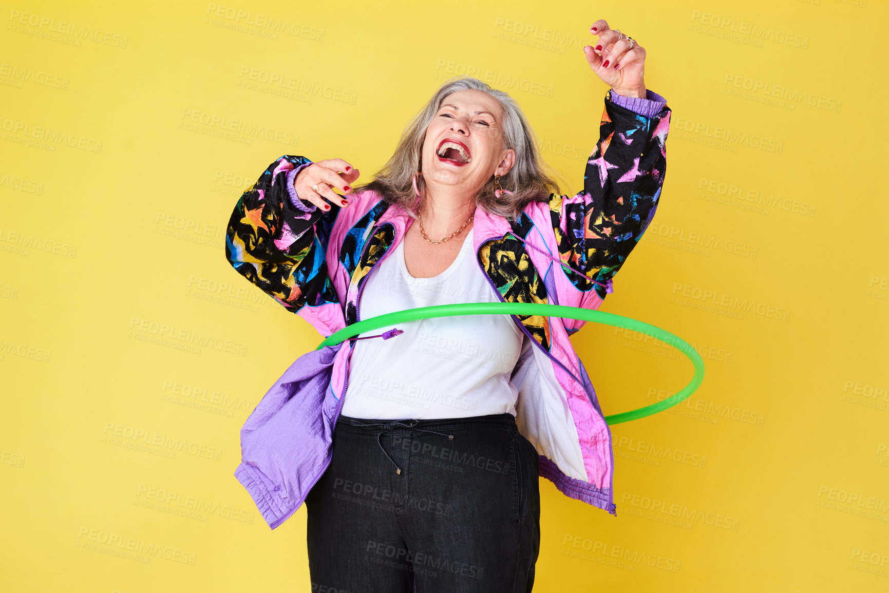 Buy stock photo Woman, dance and plastic hoop in studio for fun, happiness and elderly person with carefree, joy or smile. Senior lady, spinning and excited on background for joyful, leisure and cheerful with laugh