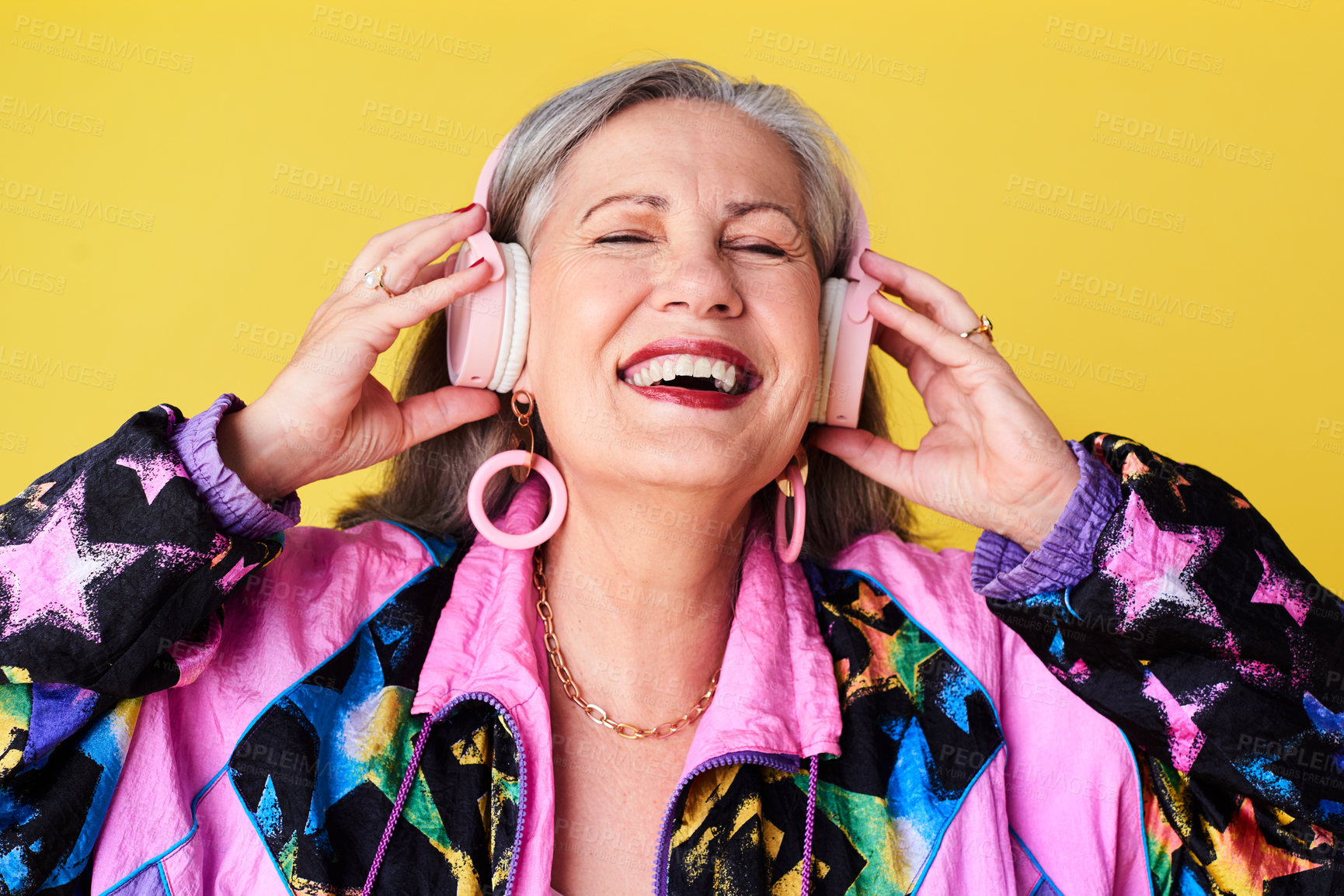 Buy stock photo Cropped shot of a cheerful and stylish senior woman listening to music on headphones against a yellow background