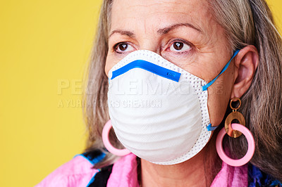 Buy stock photo Cropped shot of a quirky senior woman wearing a N95 face mask against a yellow background