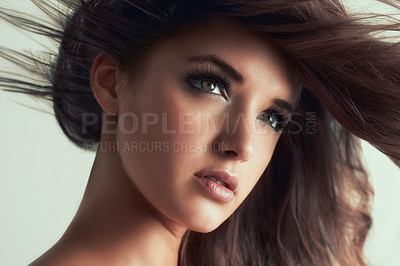 Buy stock photo Studio shot of a gorgeous young woman posing against a grey background