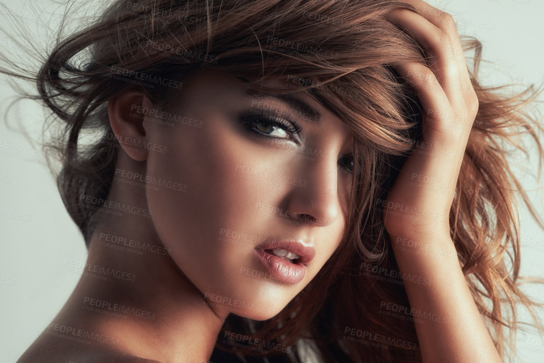 Buy stock photo Studio portrait of a gorgeous young woman posing against a grey background