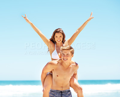 Buy stock photo Couple, piggyback and portrait at beach, summer and celebration with smile, freedom and hands in air. Young people, man and woman with vacation, comic and outdoor by romance, love and summer sunshine