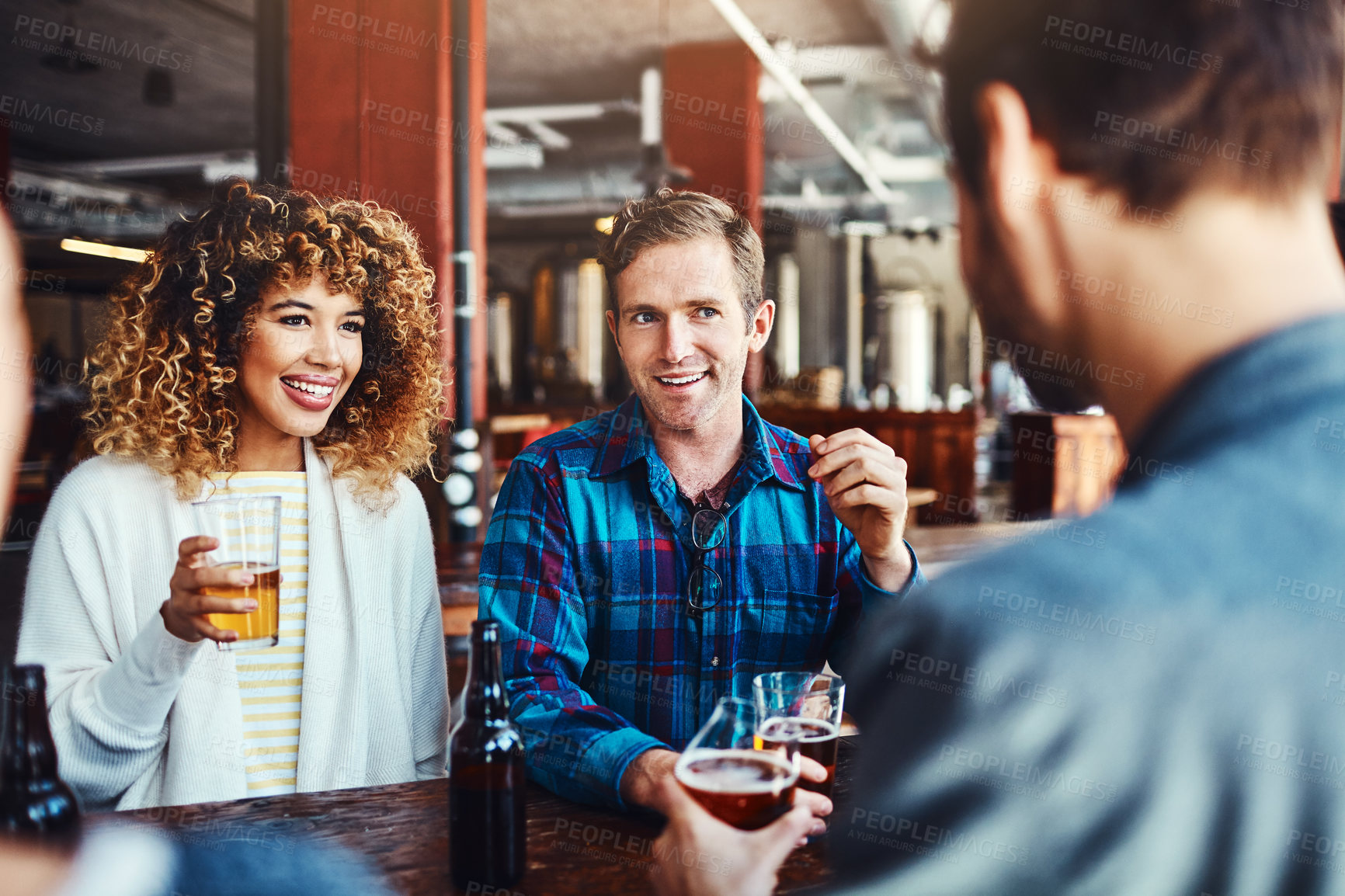 Buy stock photo Bar, couple and conversation with beer for fun, talking and celebration for raise in job with friends. Club, woman and man in party for alcohol, break and smile for weekend, enjoy and glass of drink 