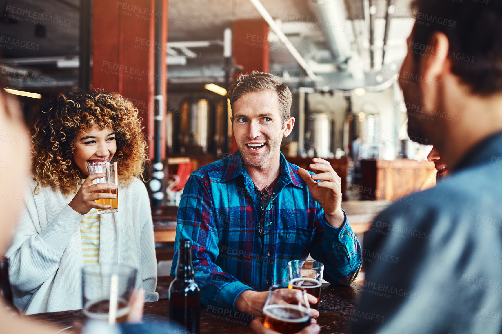 Buy stock photo Shot of a group of friends enjoying some beers at a bar