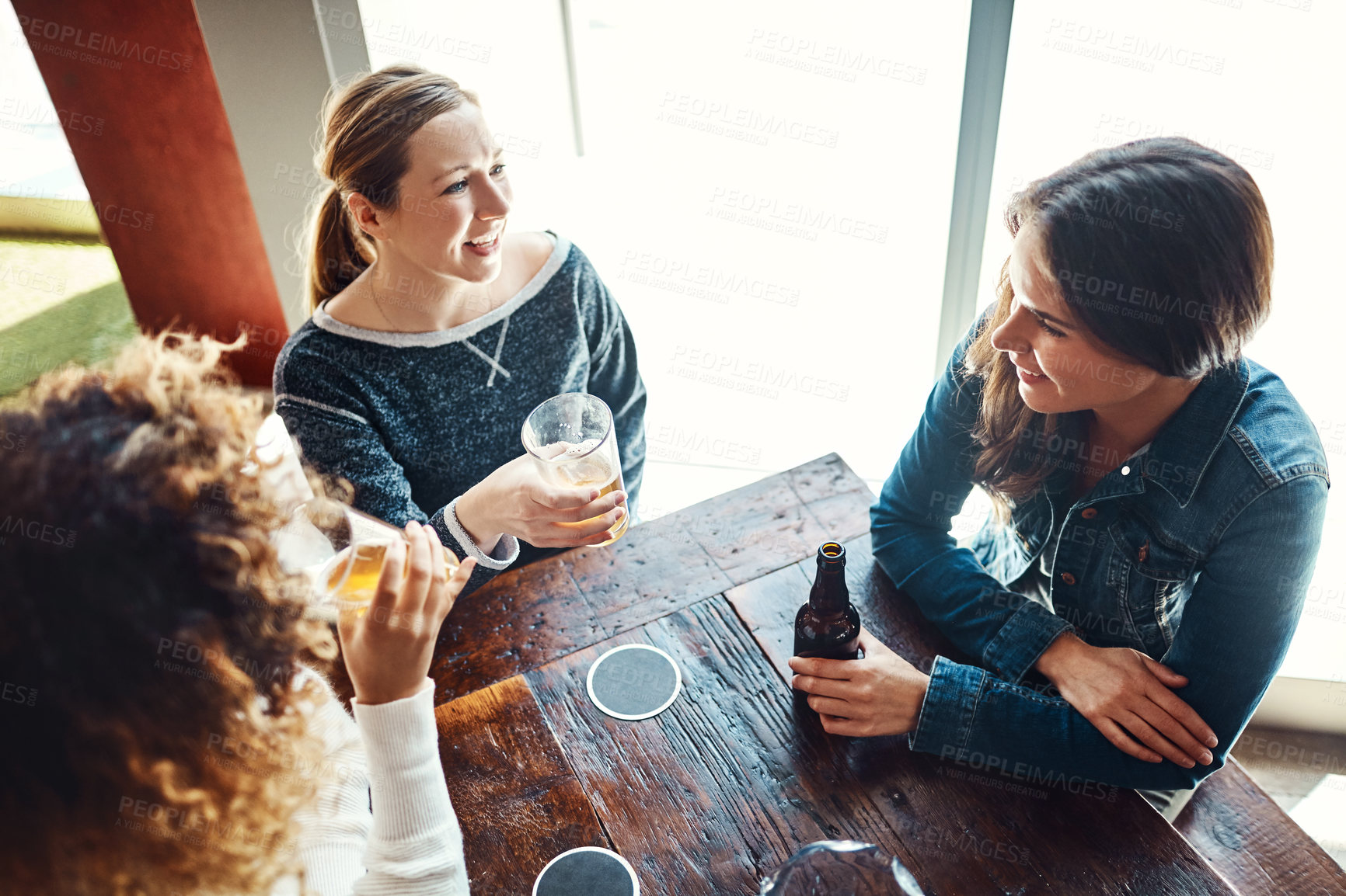 Buy stock photo Pub, friends and together for fun, beer and party of joy, gathering or celebration of group in event. Table, alcohol or drinks to enjoy, glass and people in club, break or conversation in Los Angeles