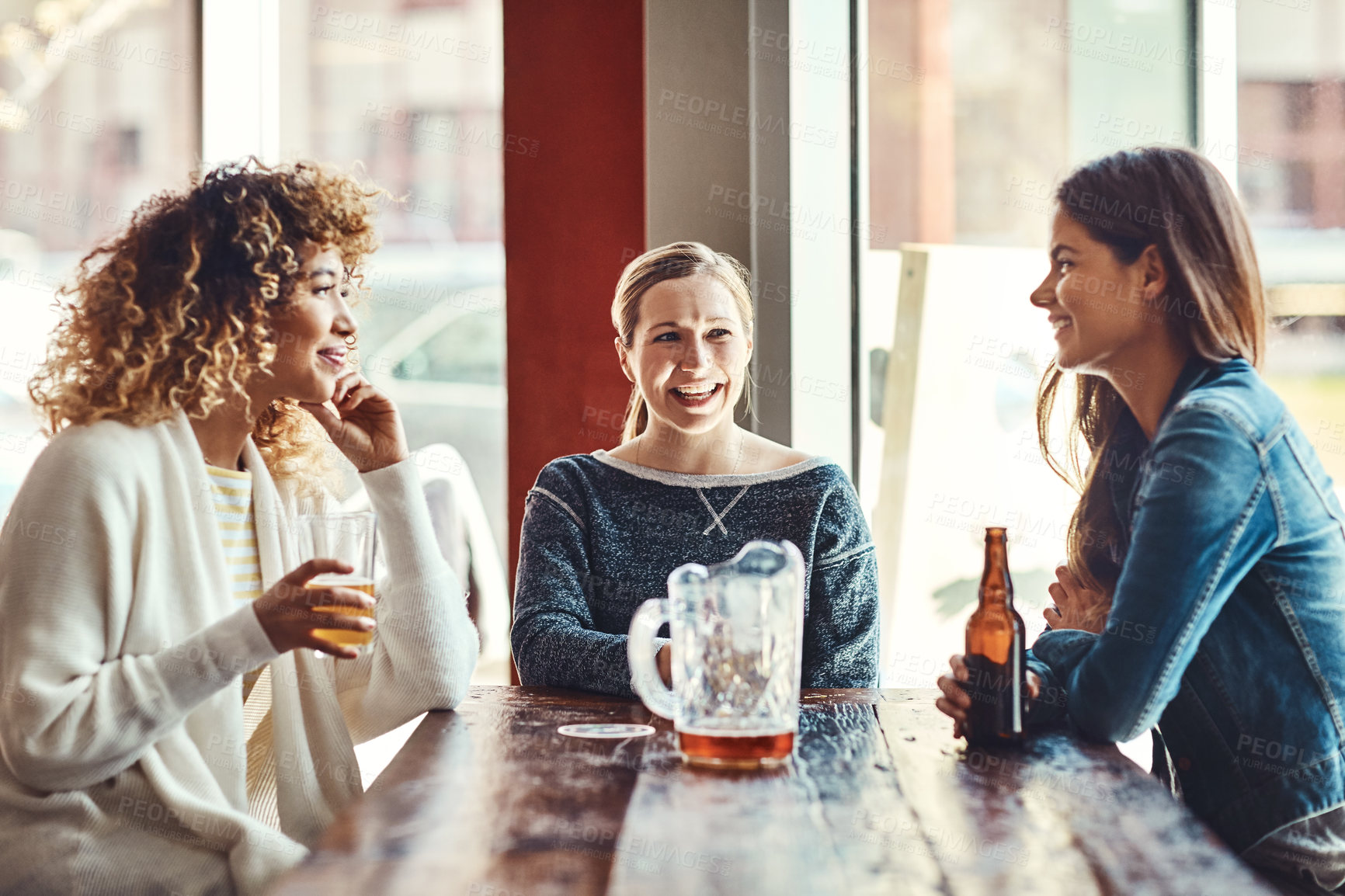 Buy stock photo Shot of a group of friends enjoying some beers at a bar