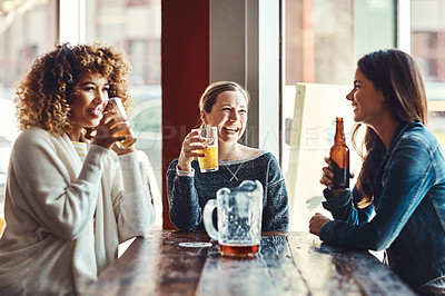 Buy stock photo Shot of a group of friends enjoying some beers at a bar