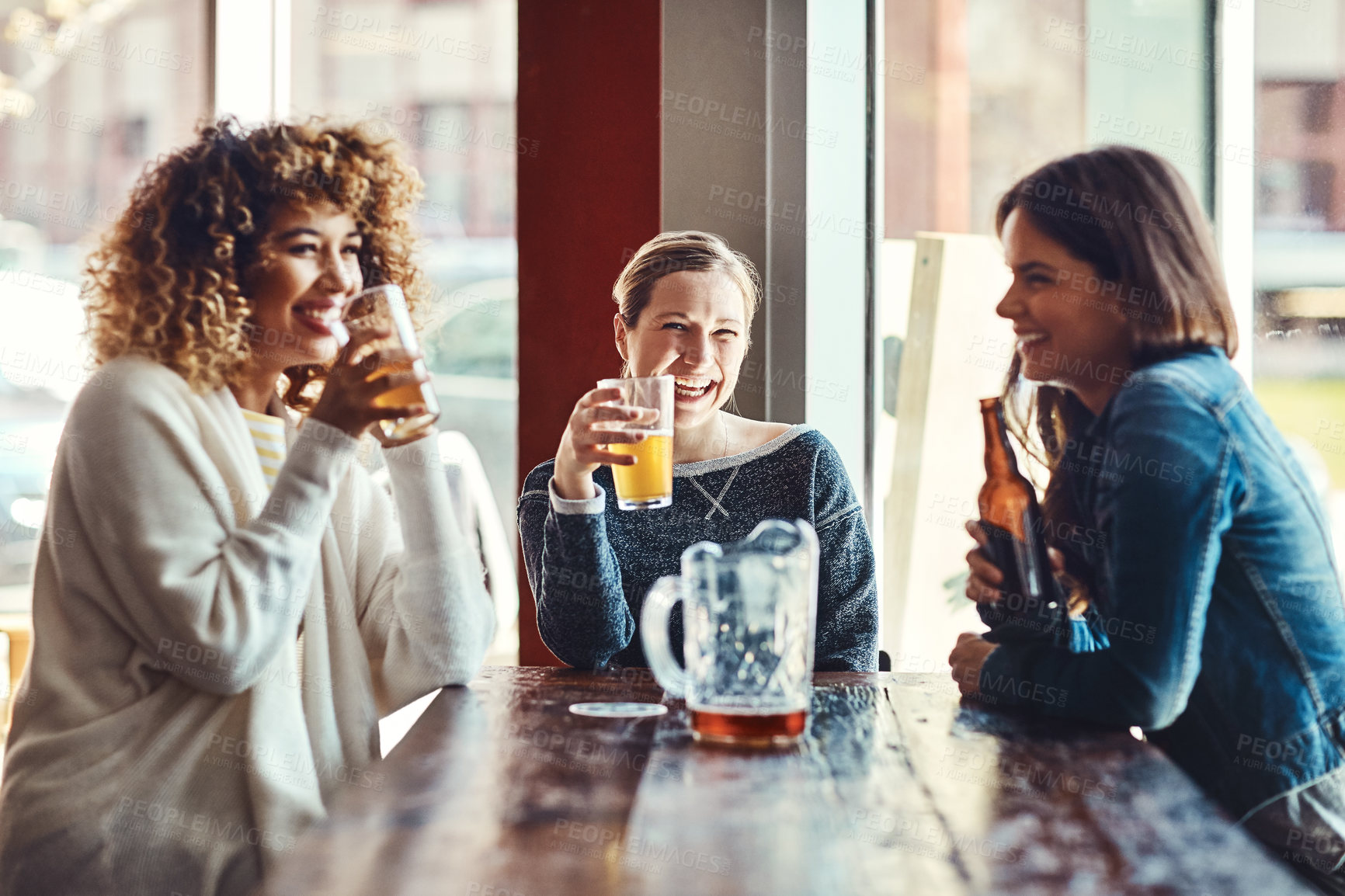 Buy stock photo Shot of a group of friends enjoying some beers at a bar