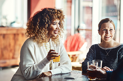 Buy stock photo Shot of friends enjoying some beers at a bar