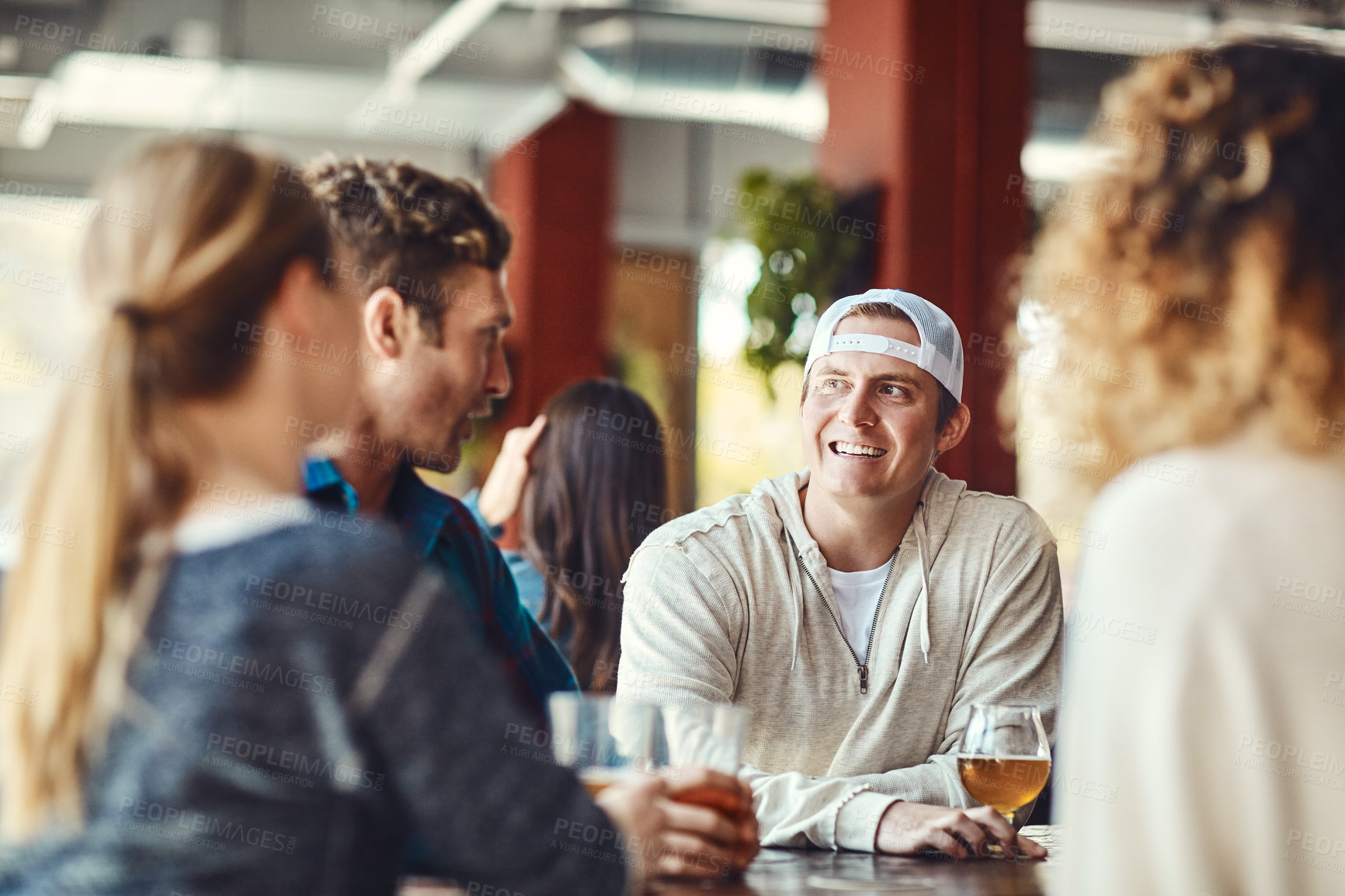 Buy stock photo Shot of a group of friends enjoying some beers at a bar