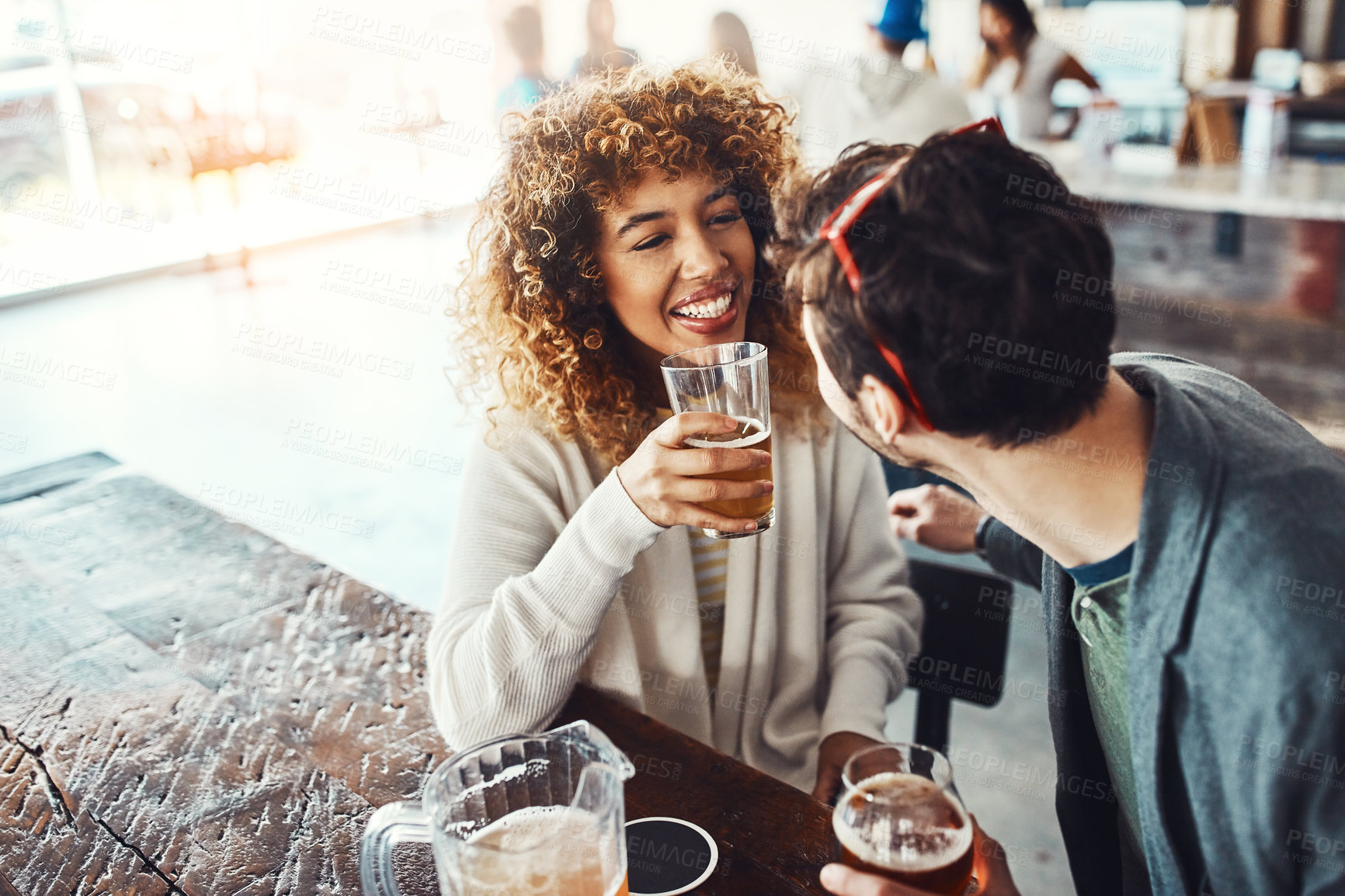 Buy stock photo Couple, beer and celebration in restaurant, smile and students with happiness, bonding together and cheerful. Break, people and man with woman, alcohol and social gathering with drinks and relax