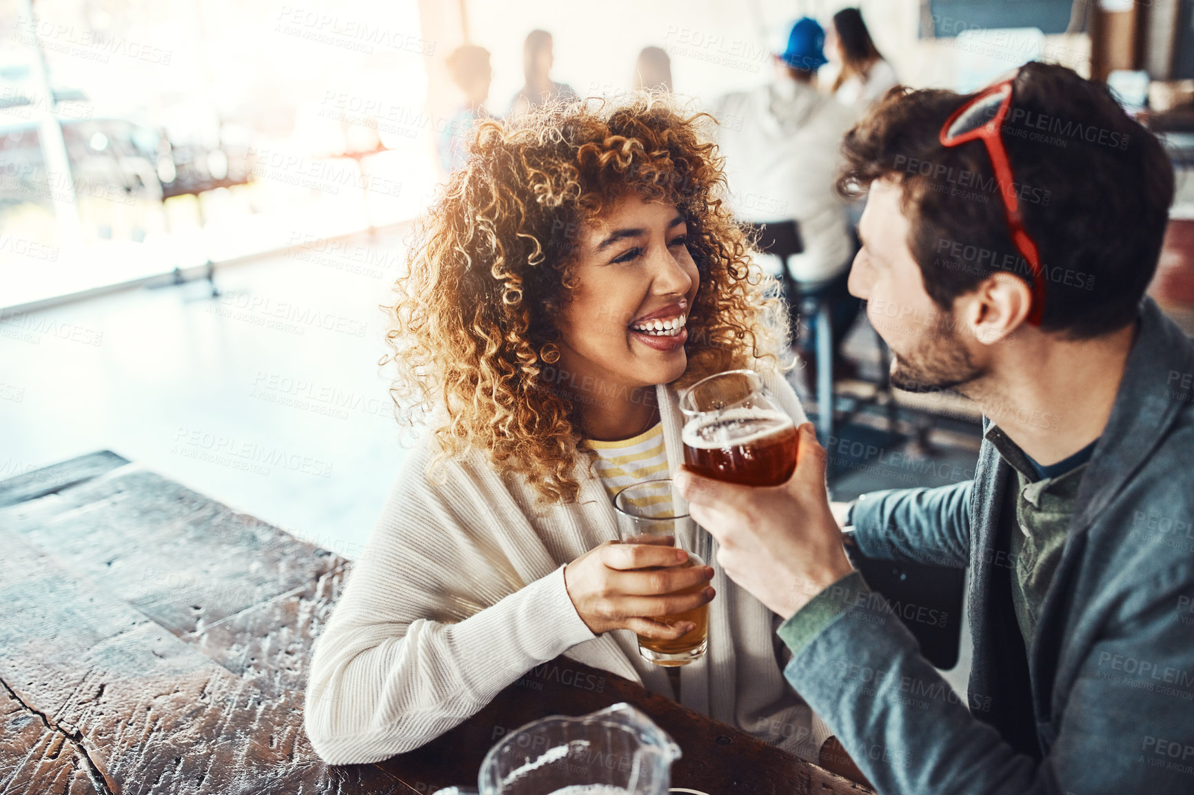 Buy stock photo Friends, beer and celebration in restaurant, cheers and students with happiness, bonding together and chilling. Relax, people and man with woman, alcohol and social gathering with drinks and joke